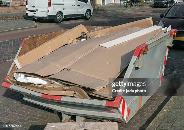gray open steel industrial waste container with cardboard waste - skip bin stock pictures, royalty-free photos & images