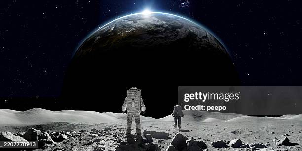 astronauts on moon watching sunrise over earth - astronaut bildbanksfoton och bilder