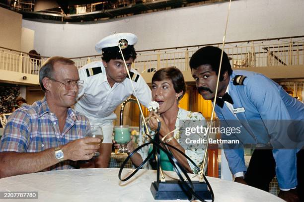 The cast of television series 'The Love Boat' pictured during a photocall, circa 1980. From left: Tom Smothers, Fred Grandy, Helen Reddy and Ted...