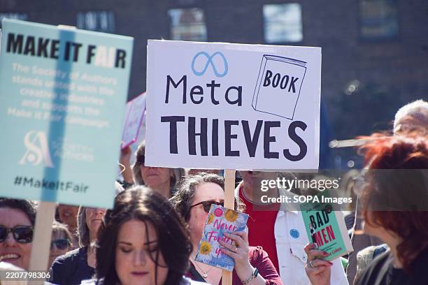 Protester holds a 'Meta book thieves' placard in King's Cross during the march to Meta offices. Book authors and publishing professionals staged a...