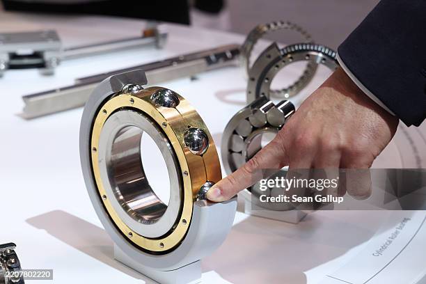 Visitor touches a ball bearing at the Schaeffler stand at the 2025 Hannover Messe industrial trade fair on March 31, 2025 in Hanover, Germany. The...