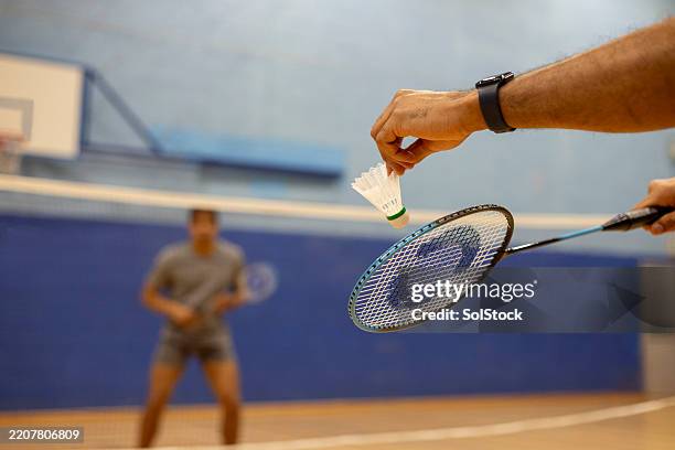 serving the shuttlecock - badminton game stock pictures, royalty-free photos & images