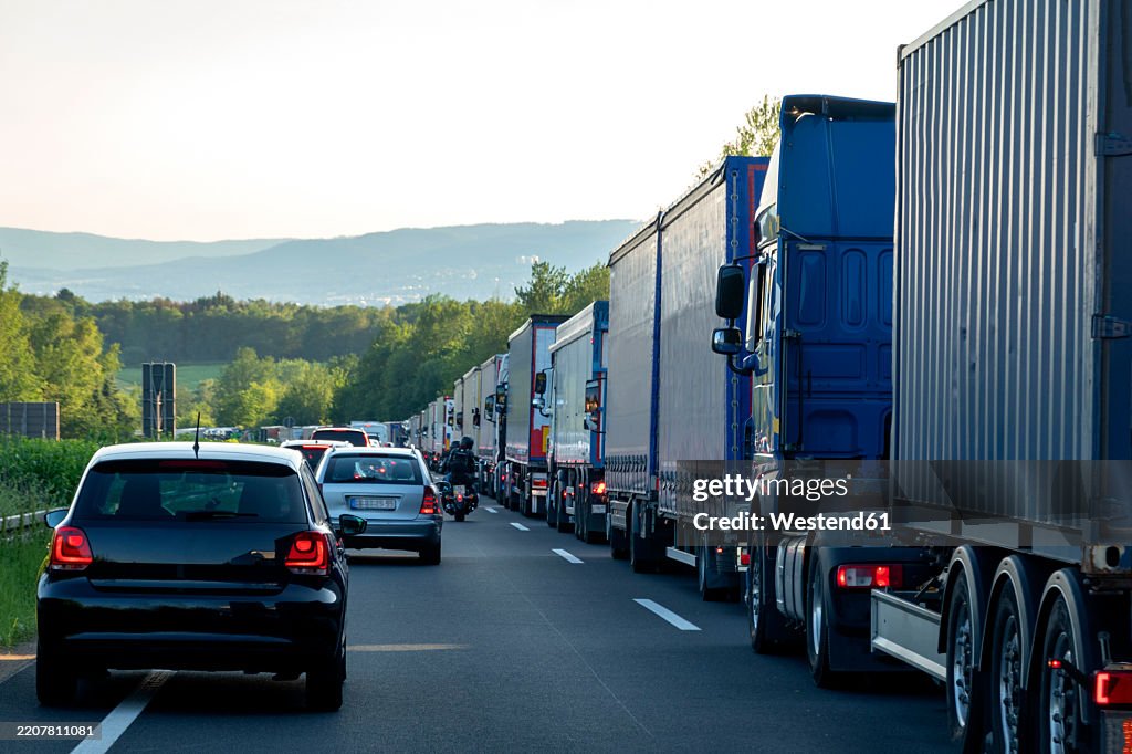Rescue lane, cars and trucks during traffic jam in the evening, Germany
