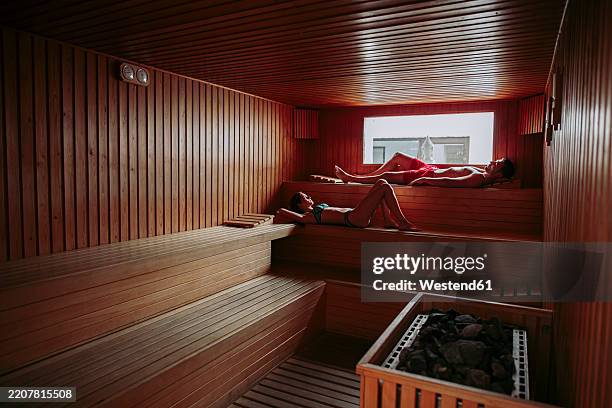 couple relaxing in a sauna - badkläder bildbanksfoton och bilder