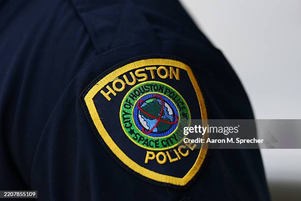 Detail shows a Houston Police uniform patch during a match between Alexander Ritschard of Switzerland and Cristian Garin of Chile on Day 1 of the...