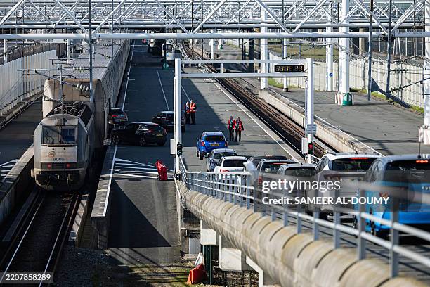 Cars board a Eurotunnel shuttle to travel to Britain from the Channel Tunnel which is operated by the company Eurotunnel, in Coquelles, northern...