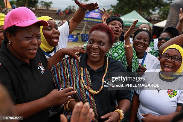 Togo's team members sing for the founder of Grannies International Football Tournament, Rebecca Ntsanwisi known as 'Mama Beka' at Nkowankowa stadium...