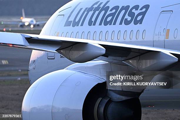 Lufthansa airline jet is pictured during the sunset at the airport in Frankfurt am Main, western Germany, on April 4, 2025.