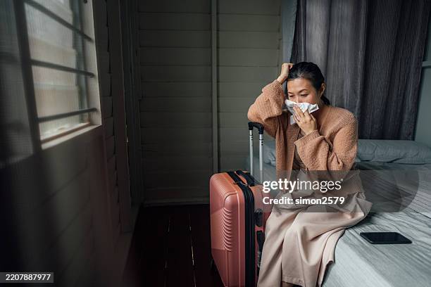 traveling with a cold: a sick woman’s battle with flu symptoms - cold virus stock pictures, royalty-free photos & images