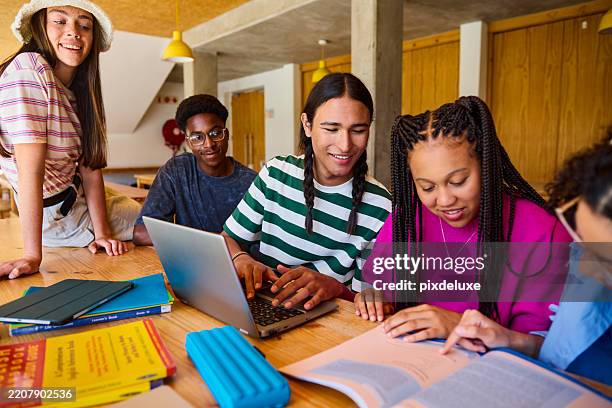 gen z students collaborating on a project using a laptop in library - highschool student stock pictures, royalty-free photos & images