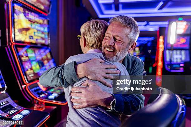 happy friends celebrating a jackpot win at a casino together - old slot machine stock pictures, royalty-free photos & images