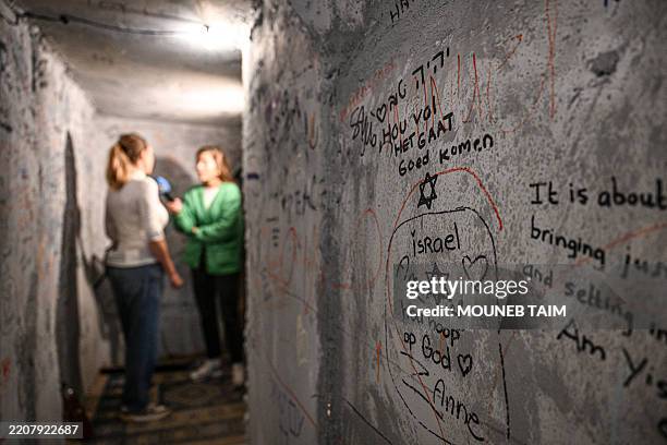 Reporter interviews a visitor in a replica of Hamas tunnels that was installed by the artist Roni Levavi in the University of Amsterdam in response...