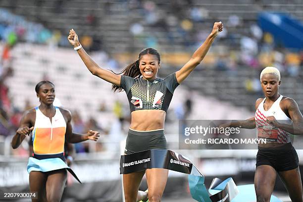 Gabrielle Thomas of team New Balance crosses the finish line in first place, alognside Britain's Dina Asher Smith and Bahrain's Salwa Eid Naser in...