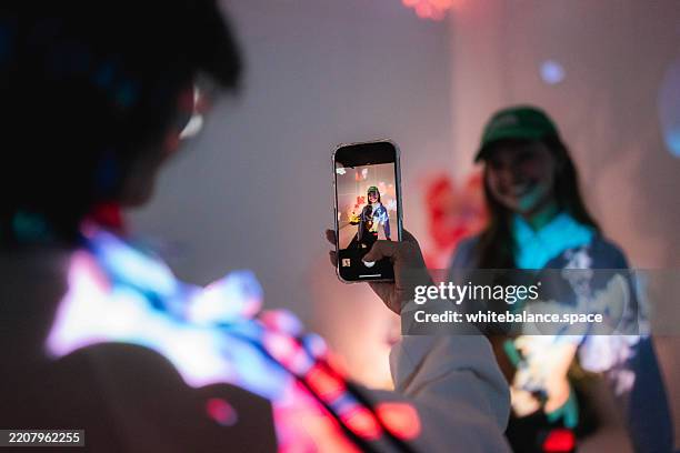 close-up shot of gen z woman taking video of art exhibition - mensagem com foto imagens e fotografias de stock