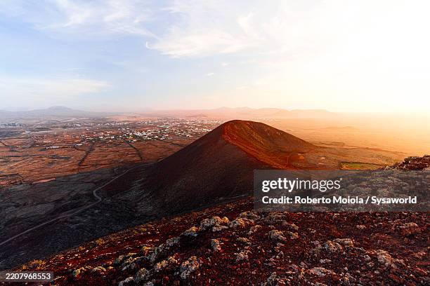 calderon hondo volcano at sunset, fuerteventura - volcanic rock stock pictures, royalty-free photos & images