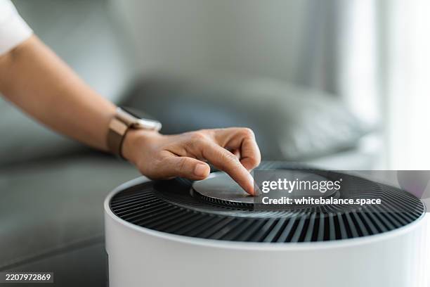senior woman using smartphone to place an online meal delivery order - air purifier stock pictures, royalty-free photos & images