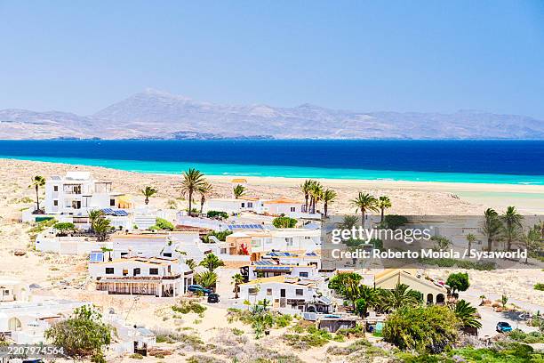 aerial view of luxury villas on a white sand beach - kanaren stock-fotos und bilder