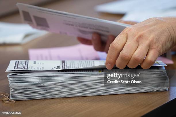 An election official counts absentee ballots a polling place inside the Heritage Oaks apartment homes on April 01, 2025 in Madison, Wisconsin. In a...