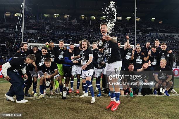 Joel Grodowski and teammates of Arminia Bielefeld celebrate victory after the DFB Cup Semi Final between DSC Arminia Bielefeld and Bayer 04...