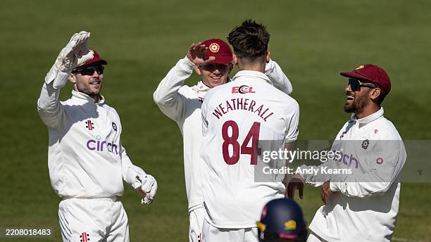 Raphael Weatherall of Northamptonshire celebrates with his team mates after taking the wicket of Ben Compton of Kent during Day Two of the Rothesay...