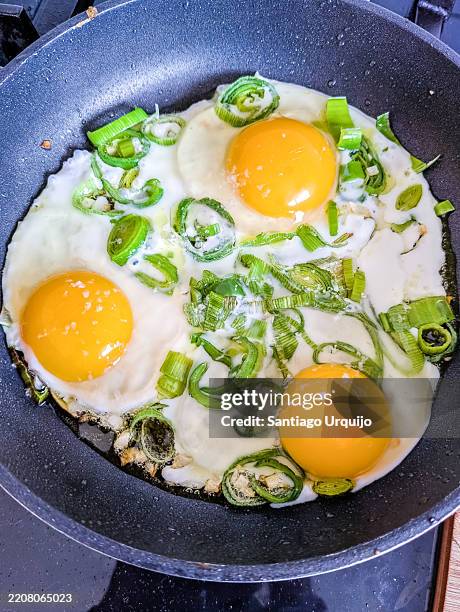 frying eggs with leeks - ghee pot stock pictures, royalty-free photos & images