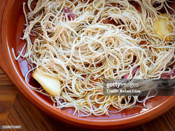 elvers cooked in garlic, olive oil and chilli - saltwater eel stock pictures, royalty-free photos & images