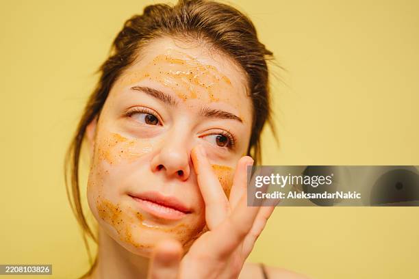 applying facial mask - exfoliation stock pictures, royalty-free photos & images