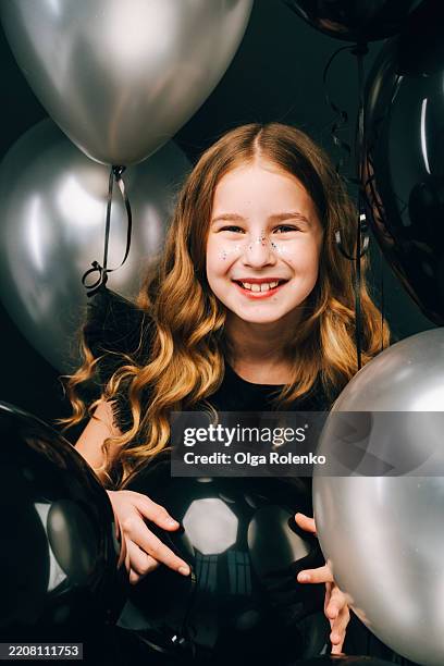 birthday girl smiling among black and silver balloons - silver dress stock pictures, royalty-free photos & images