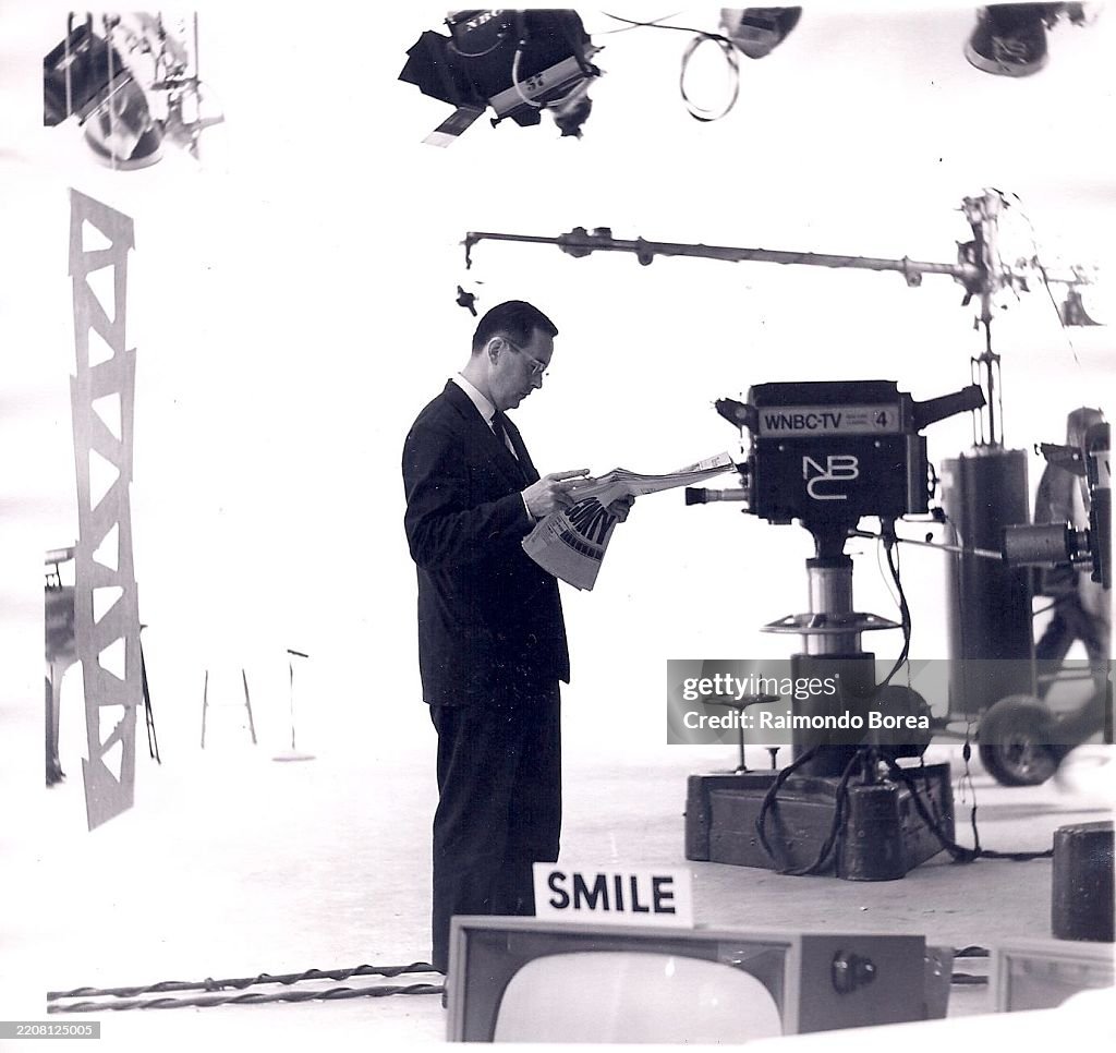 Man Reads Amidst TV Equipment