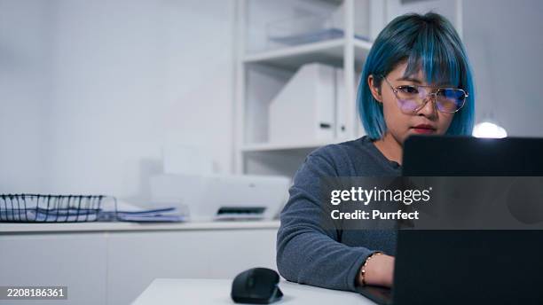 focused female software developer, programmer working on code looking at laptop computer in modern office. - writing code stock pictures, royalty-free photos & images