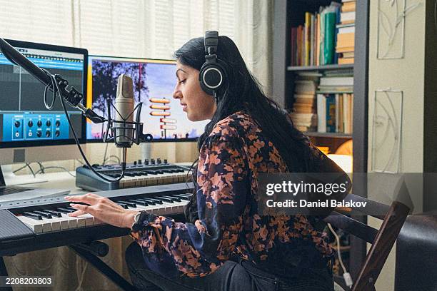 female music audio producer recording new song in studio - geluidsoverlast stockfoto's en -beelden