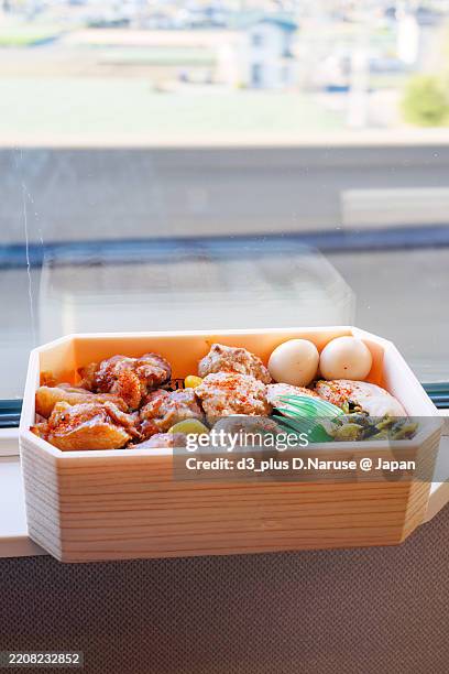 yakitori ekiben (a unique japanese boxed lunch sold at train stations) in a reserved seat.with local beer from kawagoe city, saitama prefecture.from omiya station, i boarded the joetsu shinkansen heading for niigata.omiya, saitama - november 30, 2024 - bento box stock pictures, royalty-free photos & images