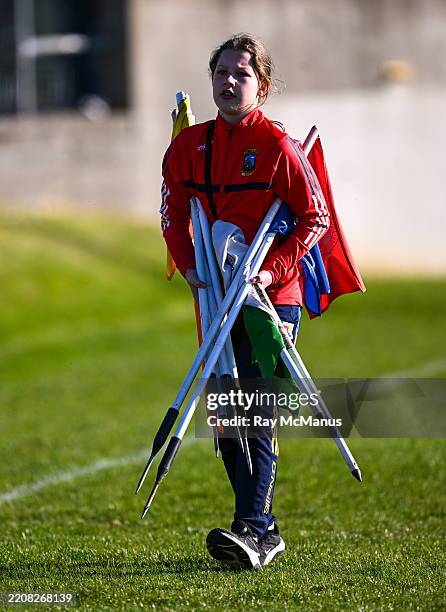 Longford , Ireland - 6 April 2025; Twelve year old Caoilin O'Reilly, from Abbeylara, in Longford, helps to collect flags after the Leinster GAA...