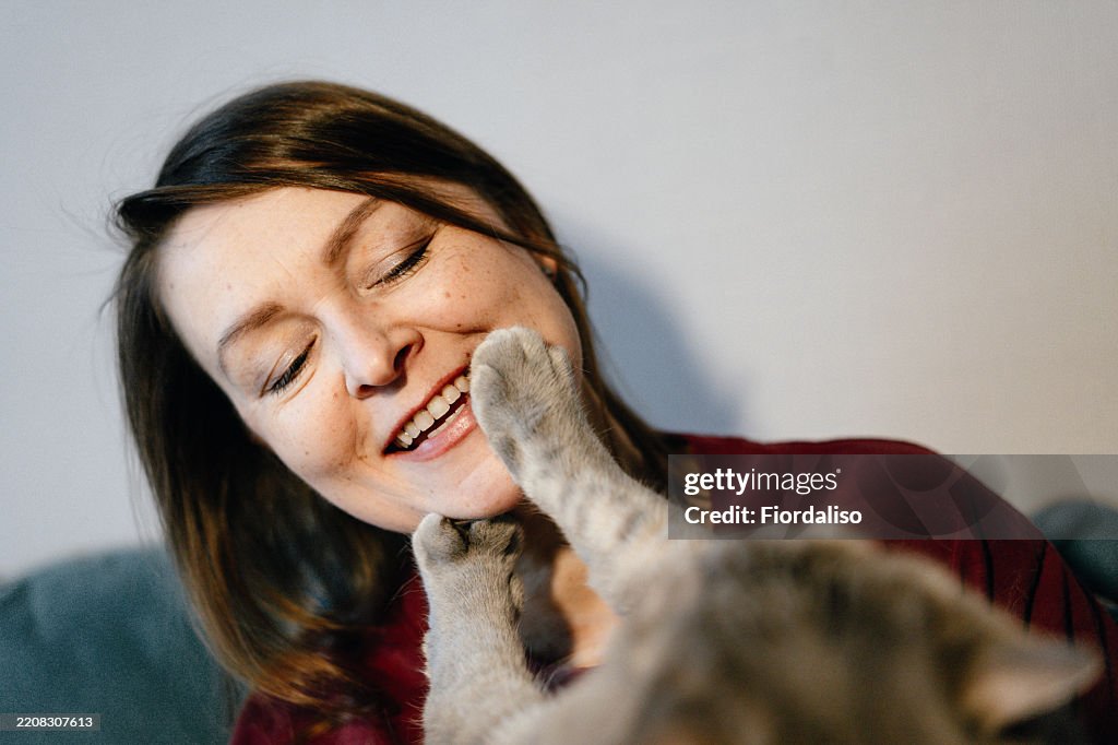 Portrait of a happy woman with domestic cat