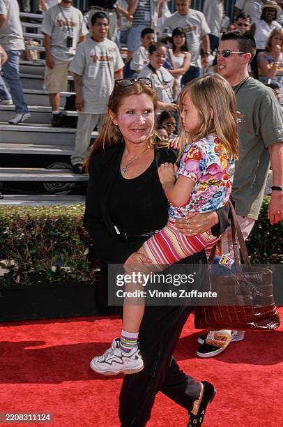 American actress Carrie Fisher carrying daughter Billie Lourd at the premiere of 'Tarzan' at the El Capitan Theatre in Los Angeles, California, June...