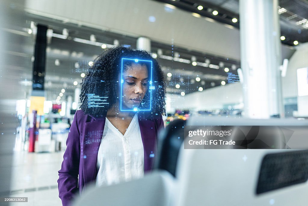 Young businesswoman undergoing facial recognition at airport check-in
