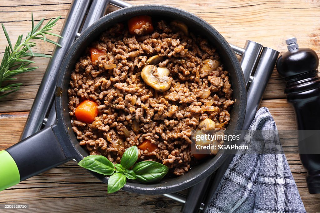 Frying meat and vegetables on hot plate