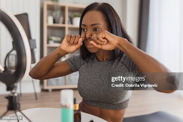 influencer making tutorial about face massage methods - sensitive content stock pictures, royalty-free photos & images