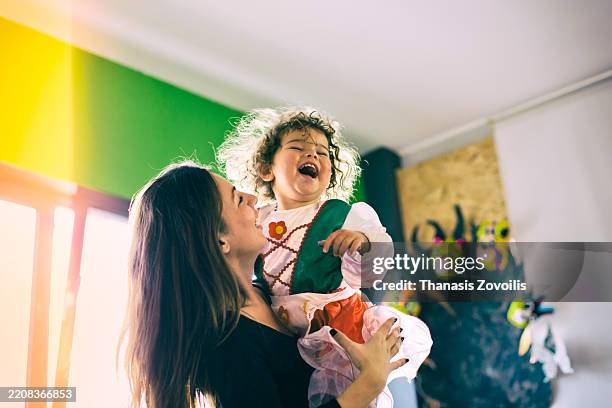 joyful moment between parent and child during festive celebration - life events stock pictures, royalty-free photos & images