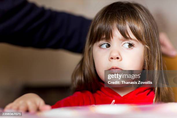 child looking concerned at dining table during a family gathering - hot red head girl stock pictures, royalty-free photos & images