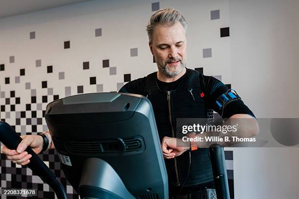 ems training on a cross trainer - elliptical machine stock pictures, royalty-free photos & images