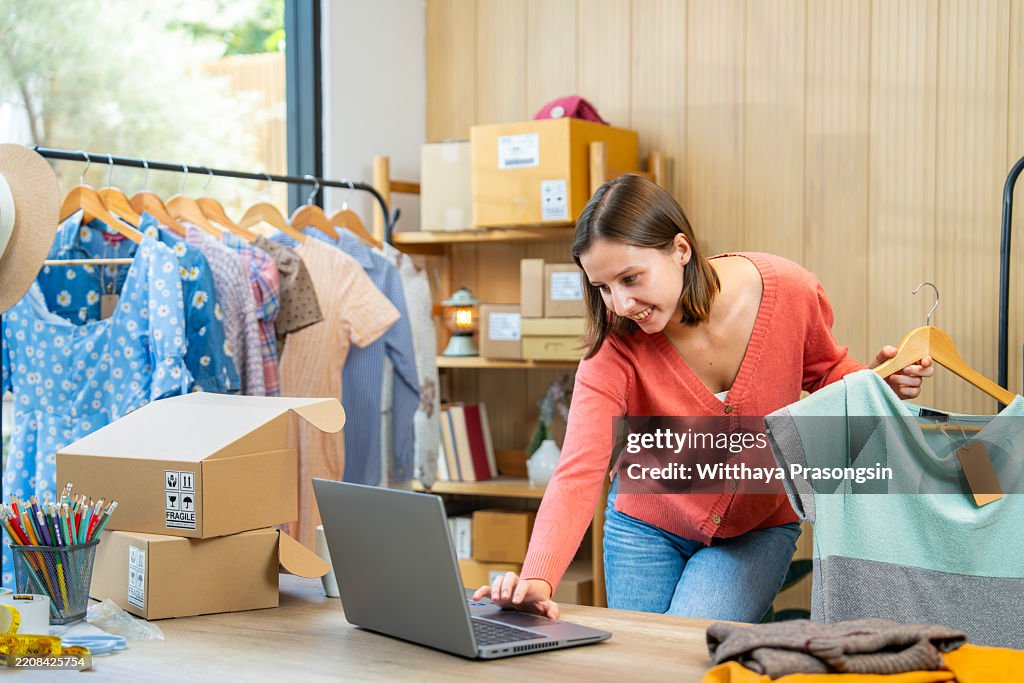 Young Entrepreneur Managing Online Clothing Business from a Home-Based Shop