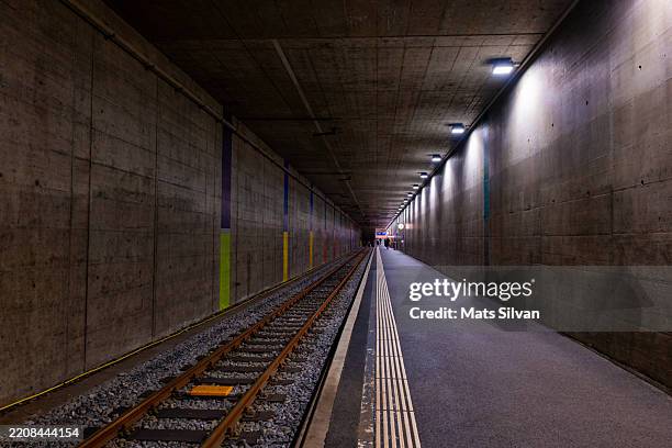 illuminated underground railway station in city of biel, bienne - train tracks end stock pictures, royalty-free photos & images