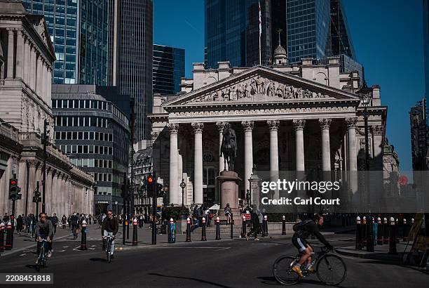 People pass the Bank of England and the Royal Exchange on April 7, 2025 in London, England. Global markets tumbled on opening today in the face of...