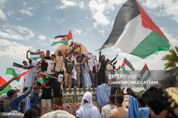 Group of people wave Palestinian flags above the replica of the Al-Aqsa Mosque at the Jerusalem roundabout, during a pro-Palestinian demonstartion...