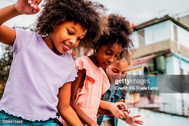 child girls playing outdoors - antilles stock pictures, royalty-free photos & images