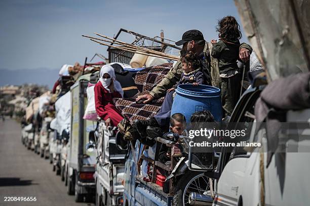 April 2025, Syria, Idlib: Displaced Syrian families form a return convoy to their destroyed village. Thousands of displaced families began returning...