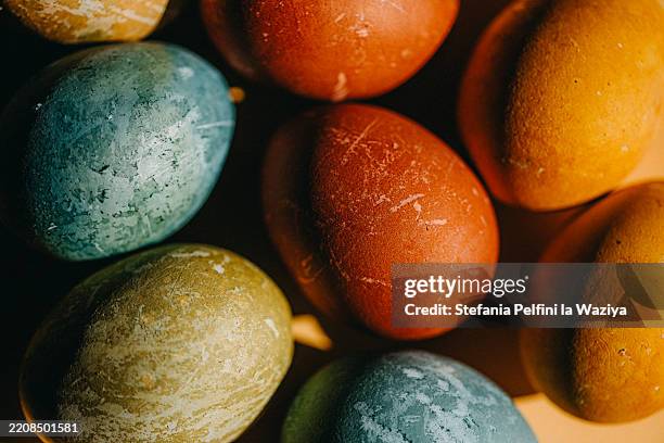 a collection of vibrantly colored easter eggs - food coloring stock pictures, royalty-free photos & images