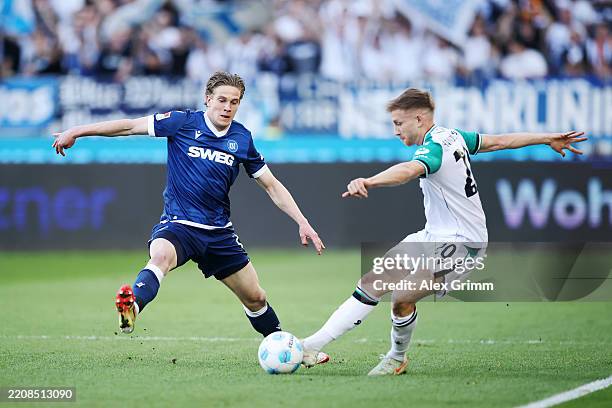 David Herold of Karlsruher SC battles for the ball with Jannik Dehm of Hannover 96 during the Second Bundesliga match between Karlsruher SC and...