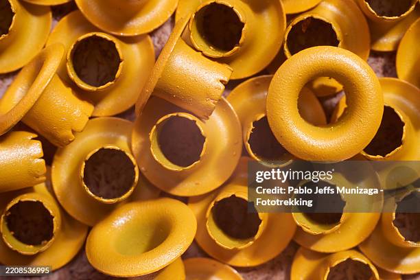 mocha eyelets punctuating textured surface, casting dynamic interplay of light and shadow across structured background - tülle stock-fotos und bilder